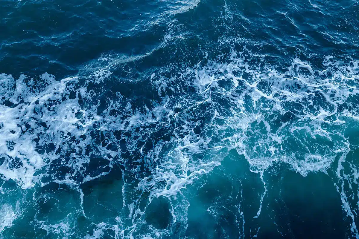 NL-Consultation Aerial view of turbulent North Sea waves and white surf, representing the Dutch offshore waters through which the Tarchon interconnector cable will pass